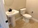 Powder room with pedestal sink and neutral tile floor at 80 Ella Ashman Ave, Henderson, NV 89011