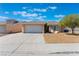 Tan house with a two-car garage and desert landscaping at 2087 Angel Falls Dr, Henderson, NV 89074