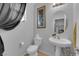 Clean bathroom with pedestal sink and toilet at 6898 Coral Cloud Ct, Las Vegas, NV 89142