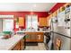 Kitchen with wood cabinets, red walls, and stainless steel appliances at 1417 Red Sunset Ave, Henderson, NV 89074