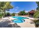 Relaxing kidney-shaped pool and spa with lounge chairs at 7045 Eldora Ave, Las Vegas, NV 89117