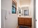 Bright bathroom with wood vanity and large mirror at 7410 Apple Springs Ave, Las Vegas, NV 89131