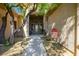 Charming courtyard entry with a walkway and lush landscaping at 7410 Apple Springs Ave, Las Vegas, NV 89131