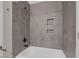 Updated bathroom with gray tile and shower/tub combo at 2407 Bonita Ln, Henderson, NV 89014