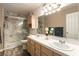 Elegant bathroom with double sinks, marble shower and updated fixtures at 8452 Boseck Dr # 287, Las Vegas, NV 89145