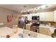 Modern kitchen with white cabinets and a breakfast bar at 8452 Boseck Dr # 287, Las Vegas, NV 89145