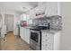 Kitchen features white cabinets, stainless steel appliances, and granite countertops at 2761 Hacienda St, Pahrump, NV 89048