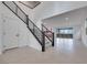 Open concept entryway with modern staircase and tile flooring at 6914 Pacific Robin St, North Las Vegas, NV 89084