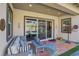 Covered patio with seating area, colorful rug, and view of backyard at 97 Juliette Pointe Ln, Henderson, NV 89011