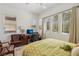 Bedroom with leafy patterned bedspread and two leather armchairs at 97 Juliette Pointe Ln, Henderson, NV 89011