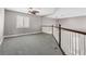 Bright loft area with window, ceiling fan, and railing at 3088 Via Flaminia Ct, Henderson, NV 89052