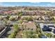 An aerial view of the house with a stunning tile roof surrounded by lush greenery and beautiful landscaping at 253 White Willow Ave, Las Vegas, NV 89123