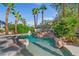 Inviting pool area features lush tropical landscaping, rock waterfall and mature palm trees at 253 White Willow Ave, Las Vegas, NV 89123