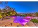 Stunning pool and spa with colorful lighting at night at 2994 San Lorenzo Ct, Henderson, NV 89052