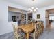 Bright dining room with a wood table, floral chairs, and a chandelier at 2341 Rosendale Village Ave, Henderson, NV 89052