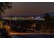 Night view of homes with city skyline in background at 2341 Rosendale Village Ave, Henderson, NV 89052