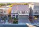 Aerial view of a two story house with a double garage and landscaping at 9883 Russian Hill St, Las Vegas, NV 89141