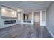 Spacious living room with gray walls, hardwood floors, and a modern fireplace at 9883 Russian Hill St, Las Vegas, NV 89141