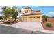 Tan two-story house with a three-car garage and mature trees at 181 Droplet St, Las Vegas, NV 89110