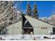 Snow-covered exterior of a building with an American flag at 324 Crestview Dr, Mount Charleston, NV 89124