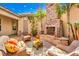 Cozy patio with wicker furniture and a stone fireplace at 48 Panorama Crest Ave, Las Vegas, NV 89135