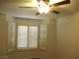 Bright bedroom with ceiling fan and window shutters at 5425 Tassara Way # 105, Las Vegas, NV 89108