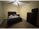 Spacious bedroom with a ceiling fan, dresser and TV at 10314 Mount Oxford Ave, Las Vegas, NV 89166