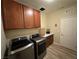 Bright laundry room with washer, dryer, cabinets, and counter space at 10314 Mount Oxford Ave, Las Vegas, NV 89166