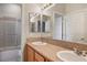 Double sink bathroom with granite countertop and adjacent shower at 2622 Rimpacific Cir, Las Vegas, NV 89146