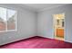 Bedroom with red carpet, window, and ensuite bathroom at 2622 Rimpacific Cir, Las Vegas, NV 89146