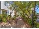 Brick pathway winds through landscaped grounds with lush greenery at 656 Tam O Shanter, Las Vegas, NV 89109