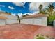 Spacious three-car garage with red concrete driveway at 3734 Mahalo Cir, Logandale, NV 89021