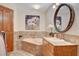 Elegant bathroom with corner bathtub, granite vanity, and large mirror at 3734 Mahalo Cir, Logandale, NV 89021