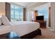 King-size bed, large windows with city views, and a built-in desk at 125 E Harmon Ave # 321, Las Vegas, NV 89109