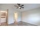 Primary bedroom with ceiling fan and access to laundry and bathroom at 601 Devonhall St # 202, Las Vegas, NV 89145