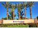 Sun City Aliante entrance with palm trees and landscaping at 7457 Widewing Dr, North Las Vegas, NV 89084