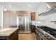 Stainless steel appliances and wood cabinets highlight this kitchen at 3640 Ash Springs Way, Las Vegas, NV 89129