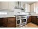 Modern kitchen with stainless steel range and marble backsplash at 3640 Ash Springs Way, Las Vegas, NV 89129