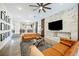 Open concept living room with marble feature wall and tan couches at 3640 Ash Springs Way, Las Vegas, NV 89129