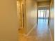 Bright hallway with light wood tile floors and neutral walls at 72 Ella Ashman Ave, Henderson, NV 89011