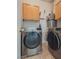 Laundry room with washer, dryer, and overhead cabinets at 8627 Roping Rodeo Ave # 103, Las Vegas, NV 89178