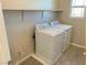 Laundry room with washer, dryer, and overhead shelving at 7215 Stockton Dunes St, North Las Vegas, NV 89084