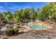 Relaxing backyard with a stunning pool and waterfall feature at 10528 Meadow Mist Ave, Las Vegas, NV 89135