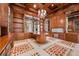 Luxurious library with custom wooden cabinetry and a large table at 9409 Kings Gate Ct, Las Vegas, NV 89145