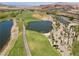 Aerial view of a golf course with palm trees and a lake at 31 Via Mantova # 1, Henderson, NV 89011