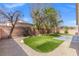 Artificial turf backyard with gravel perimeter and a patio at 4029 Allyson Rae St, North Las Vegas, NV 89032