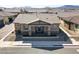 Tan house with tile roof and landscaping, front view at 783 Hibiscuss Blossom St, Henderson, NV 89011