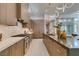 Modern kitchen with wood cabinetry and herringbone backsplash at 40 Reflection Shores Ln, Henderson, NV 89011