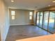 Bright living room with wood-look tile floors and sliding glass doors at 2252 Bird Of Prey St, Las Vegas, NV 89138