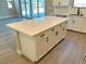 Large kitchen island with white cabinets and a quartz countertop at 2252 Bird Of Prey St, Las Vegas, NV 89138